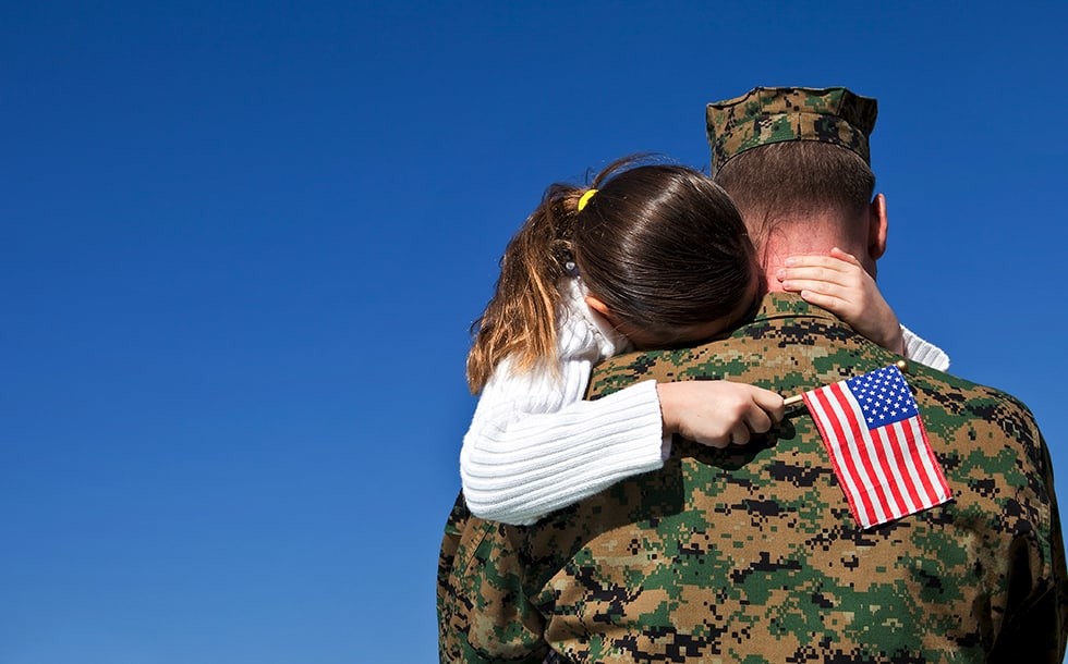 Girl being carried by soldier